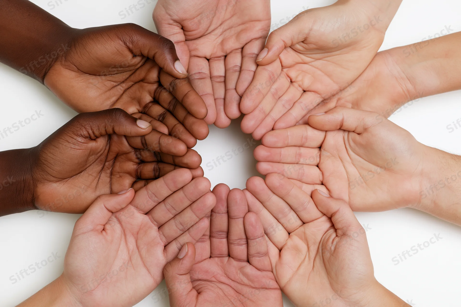 Diverse hands arranged in a circle palms facing inward on white background