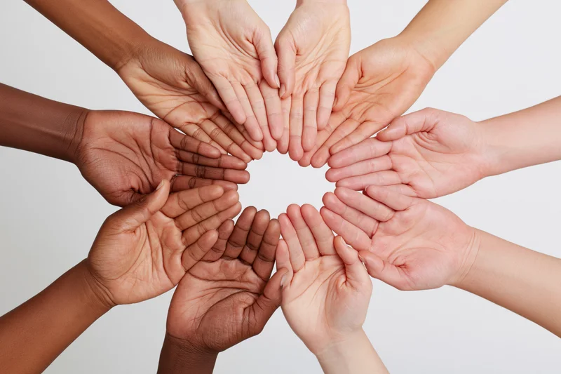 Diverse hands forming a circle in a studio setting
