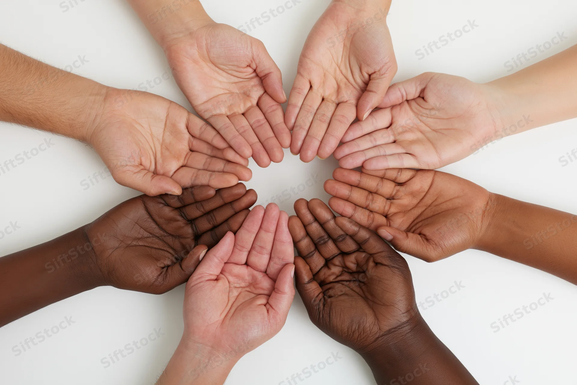 Diverse hands arranged in a circle on white background