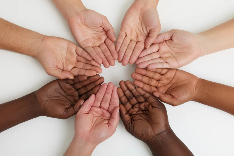Diverse hands arranged in a circle on white background