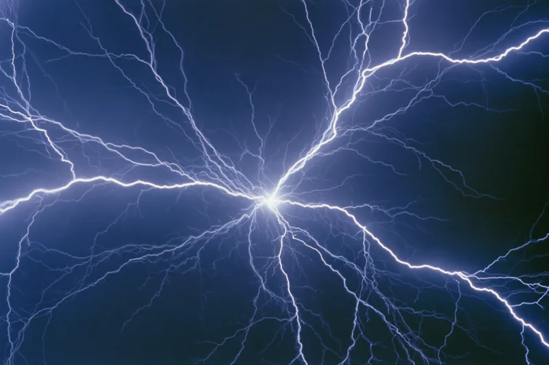 Branching lightning bolts radiating from a central point against a dark blue background