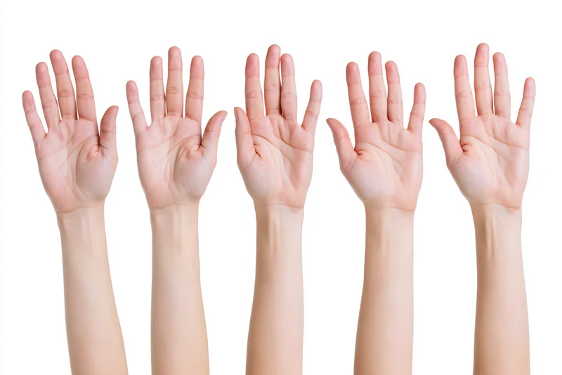 Five female hands raised palm up against a white background