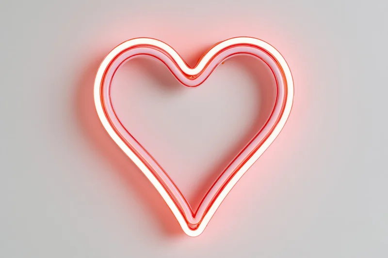 Glowing neon heart outline mounted on a white wall