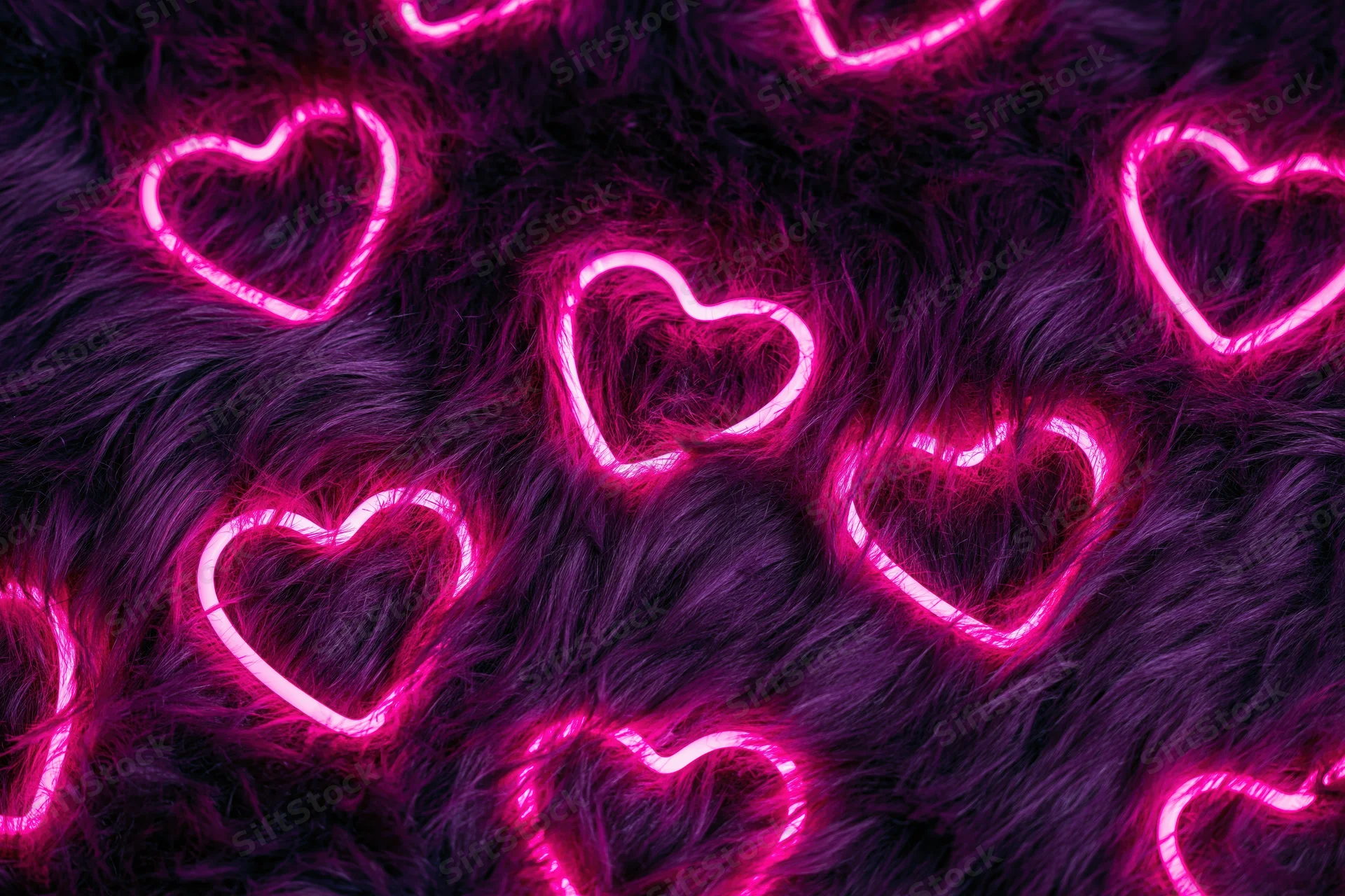 Glowing pink neon heart outlines scattered across dark faux fur surface