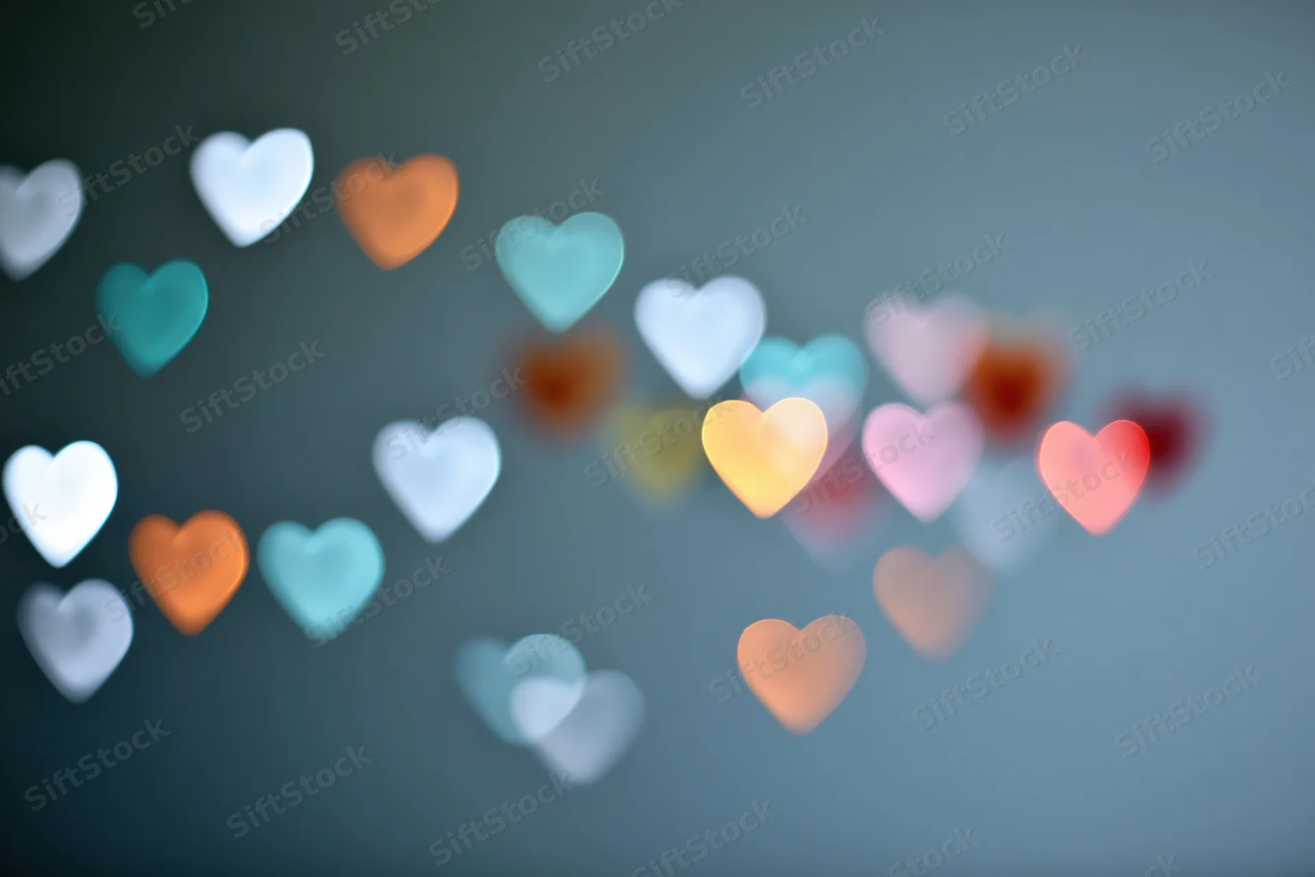 Heart-shaped bokeh lights scattered across a soft blurred background