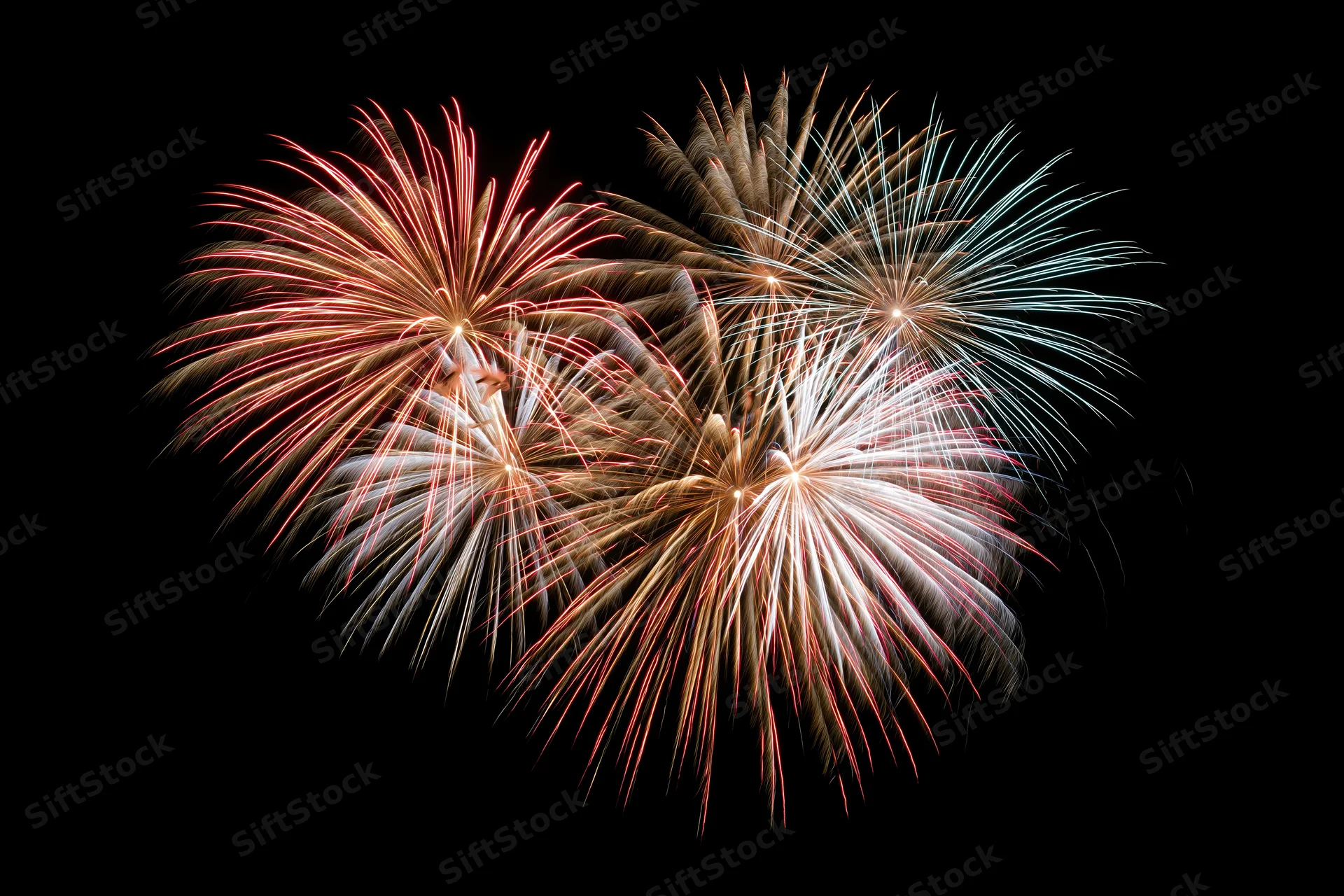 Fireworks bursting in a heart-shaped pattern against a dark night sky