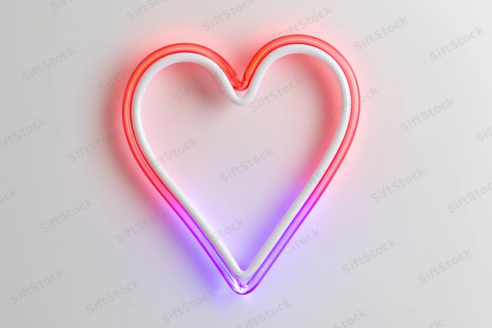 Neon heart outline glowing in red and purple on a white background
