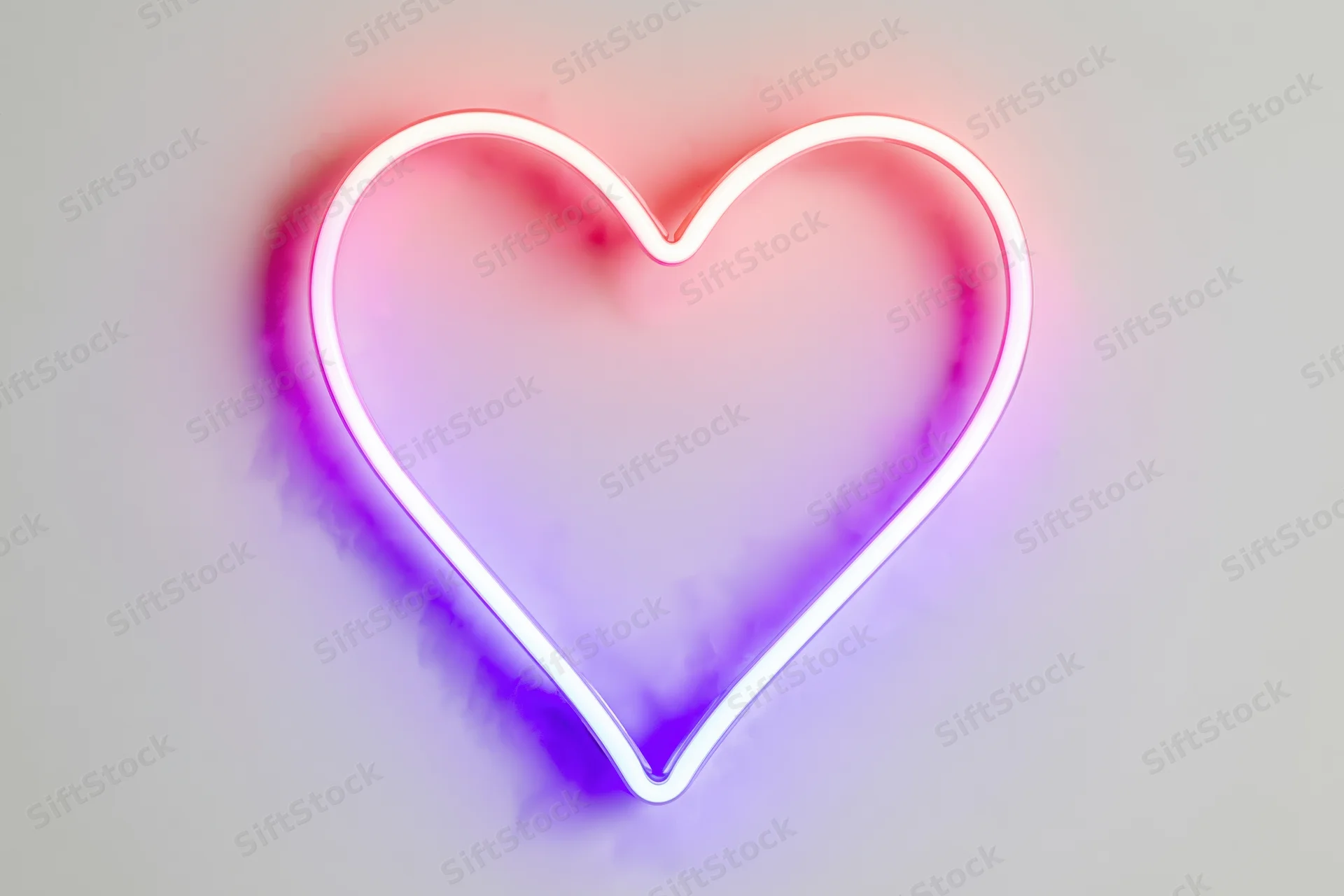 Neon heart outline glowing with pink and purple light on white background
