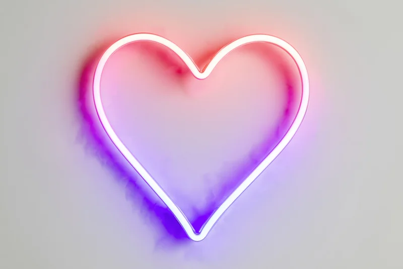 Neon heart outline shape centered on a pure white background