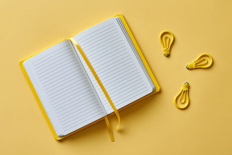 Open blank lined notebook with yellow ribbon and three lightbulb shapes on a bright yellow surface