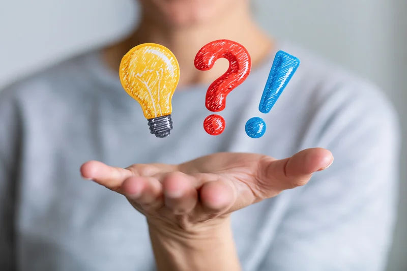 Woman holding open palm with floating lightbulb, question mark and exclamation mark above it
