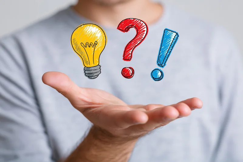 Man holding open palm with illustrated lightbulb, question mark and exclamation mark floating above it