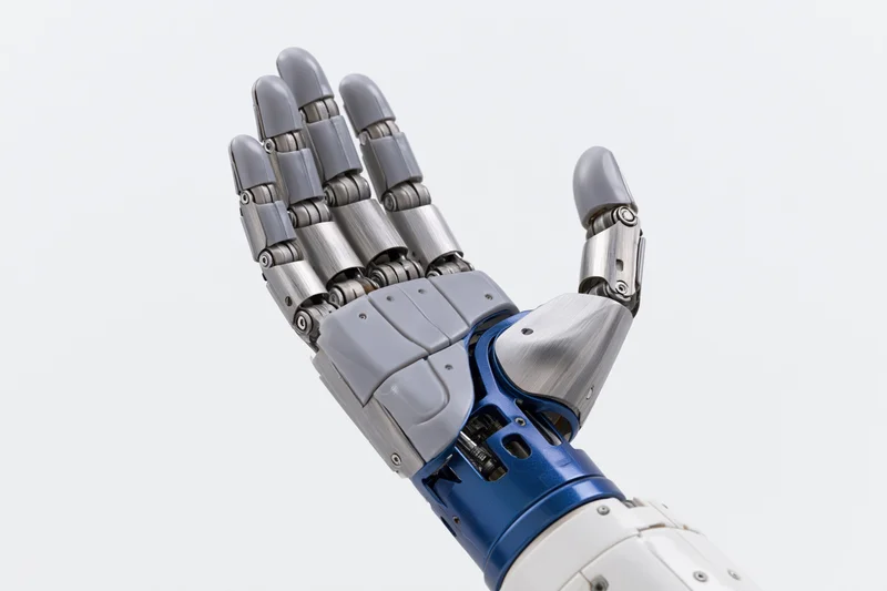 Robotic prosthetic hand raised with open palm against white background
