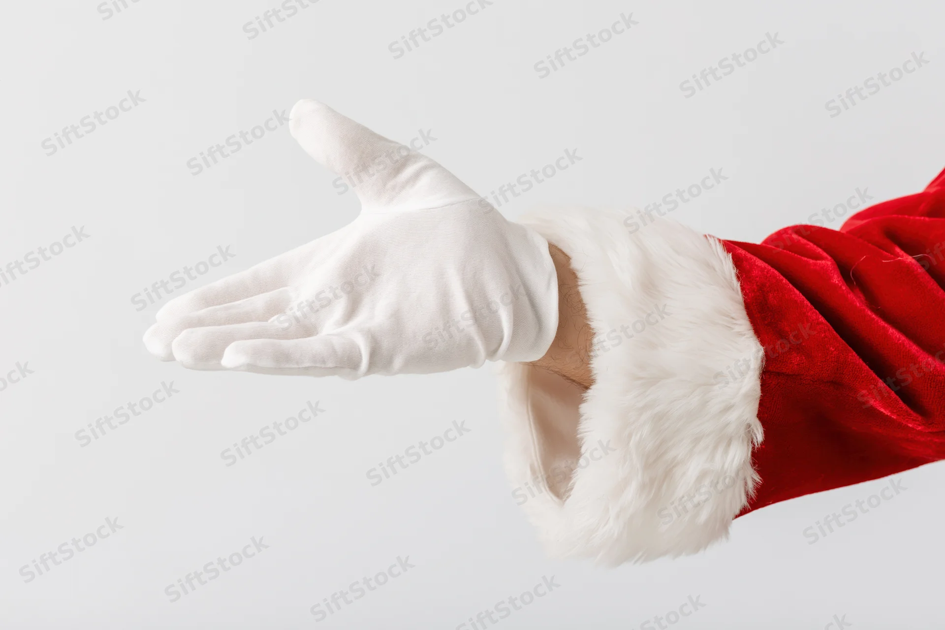 Santa's gloved hand extended palm up against white background