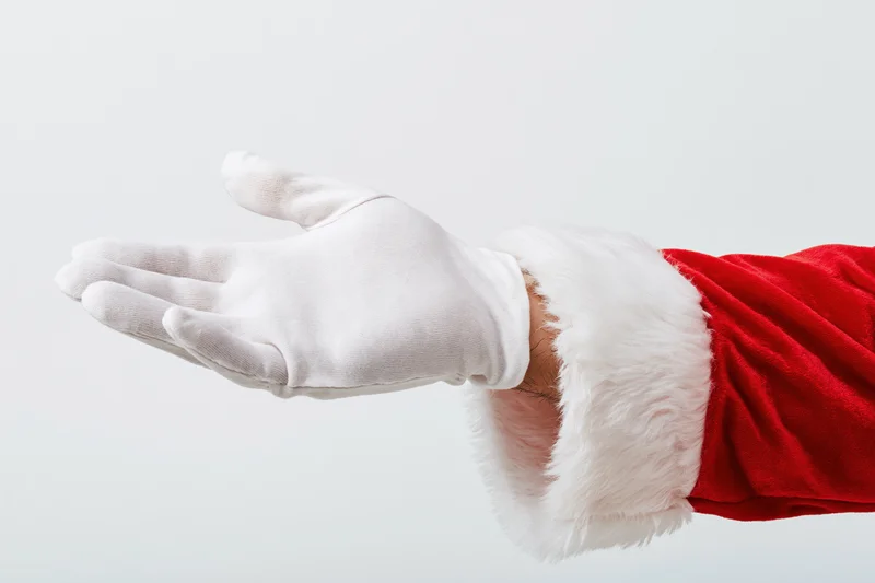 Santa's gloved hand extended palm up against white background