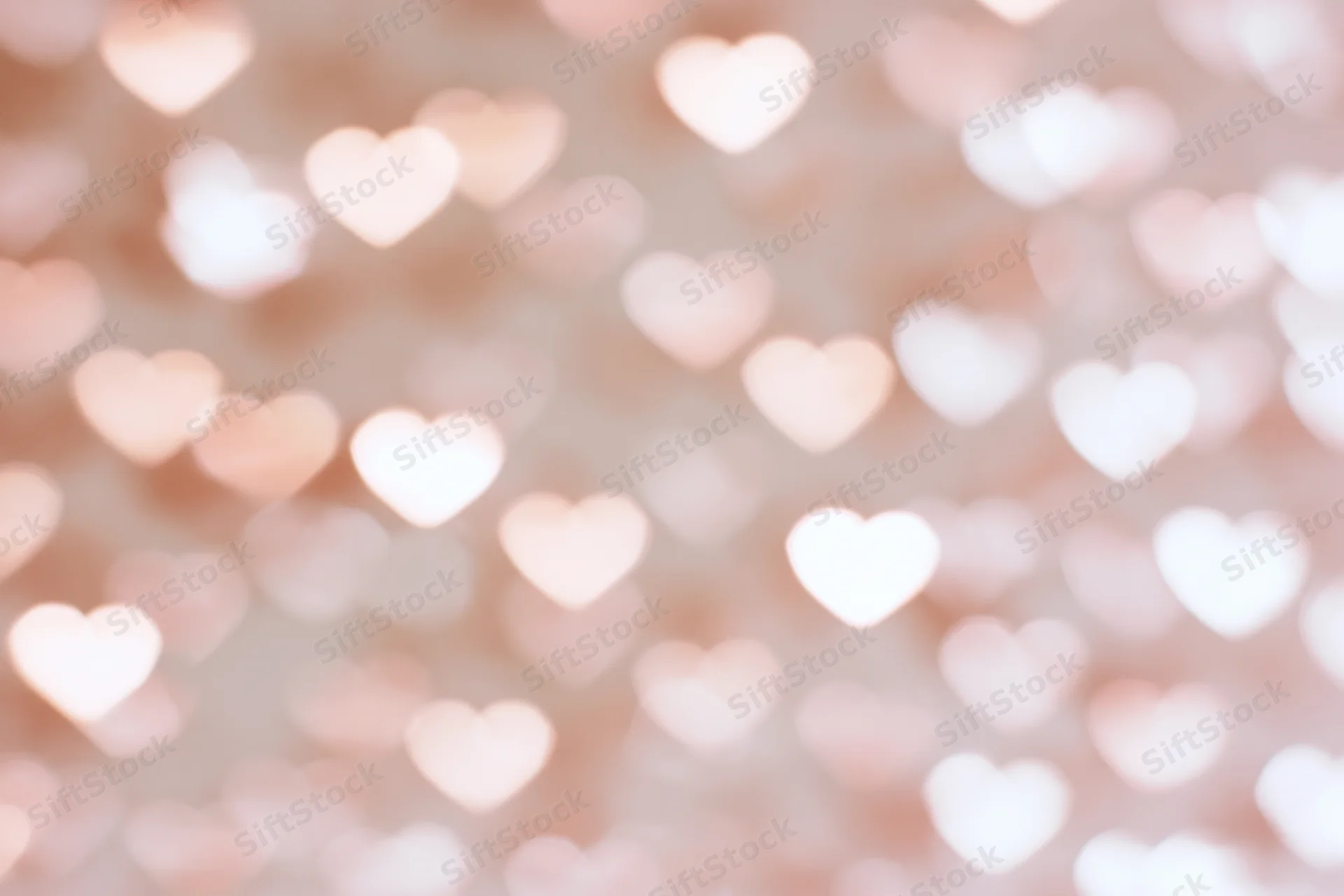 Soft bokeh background with out-of-focus heart shapes in pink and white light