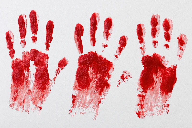 Three red handprints pressed and dragged downward on white paper