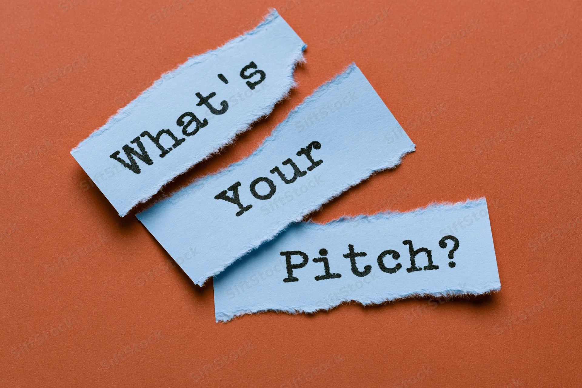 Torn blue paper strips with text what's your pitch on orange background