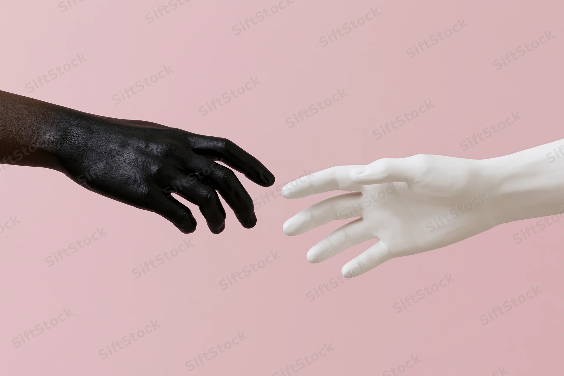 Two mannequin hands reaching toward each other against a pink background