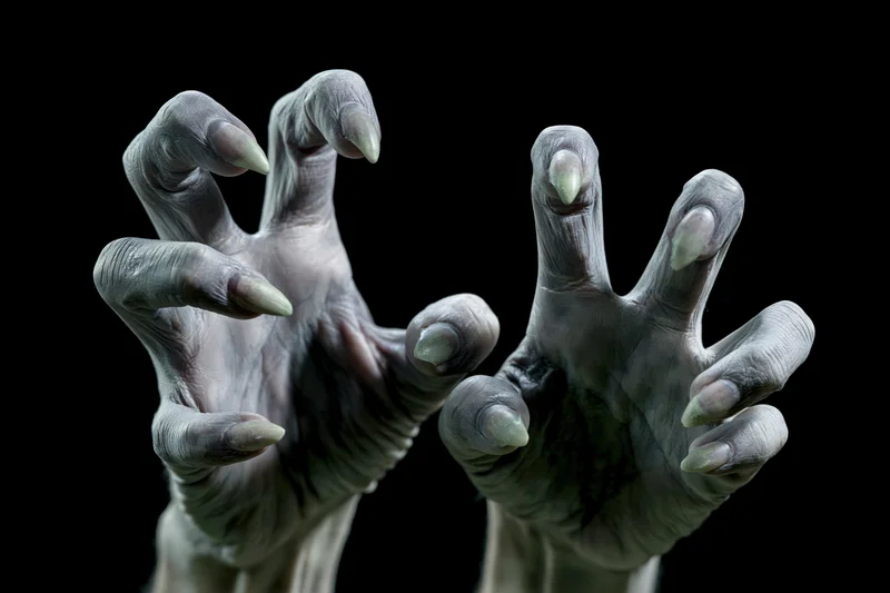 Pale grey clawed hands reaching forward from darkness