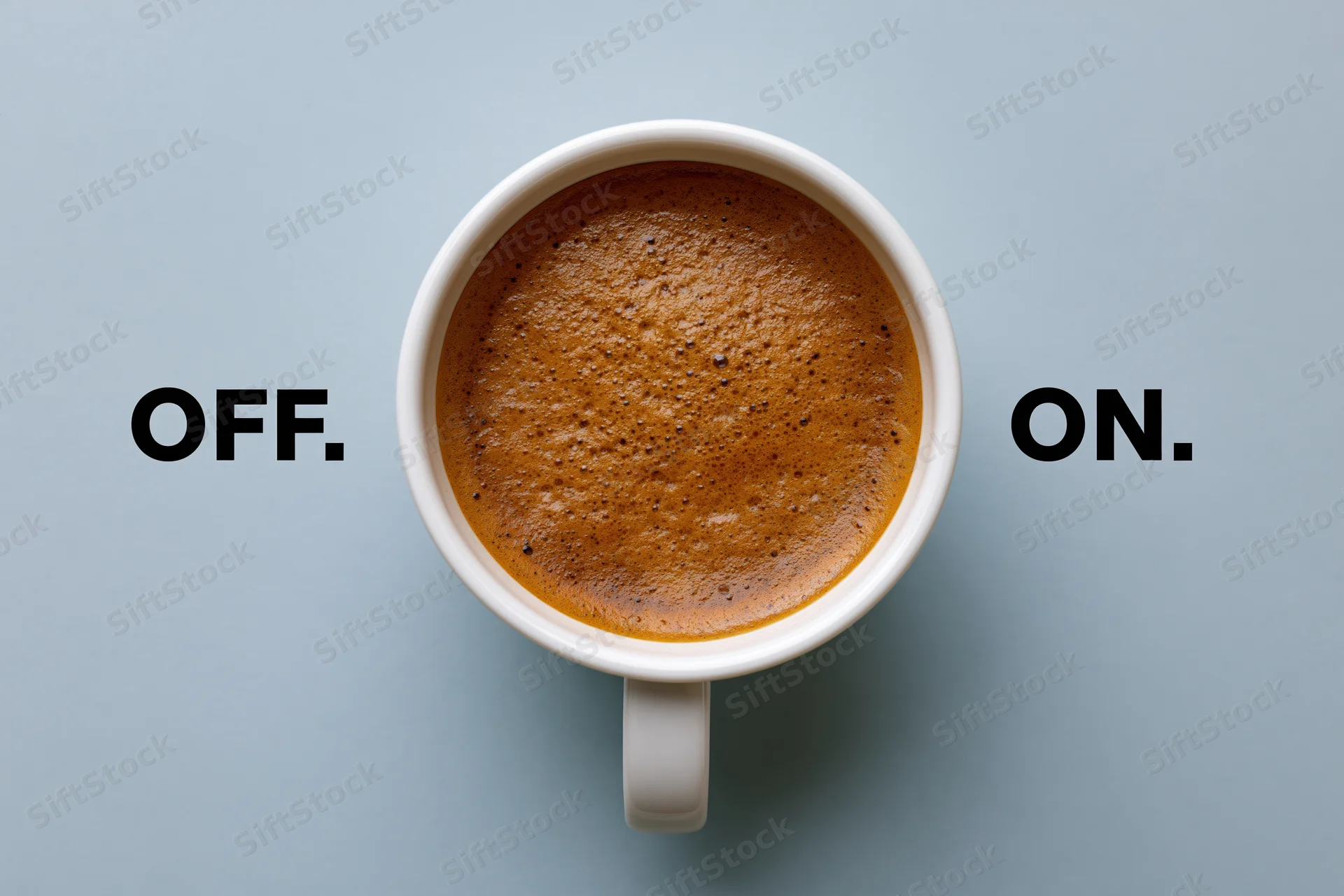 White ceramic coffee mug filled with espresso crema viewed from above on a light blue surface with the words off and on on either side