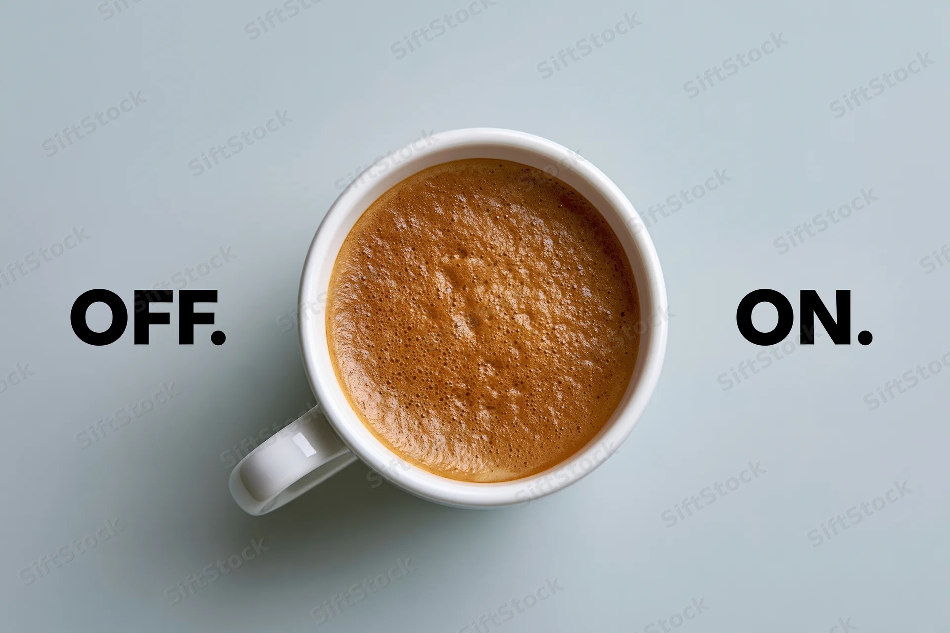 White ceramic coffee mug filled with espresso crema viewed from above on a gray surface with text labels off and on on either side