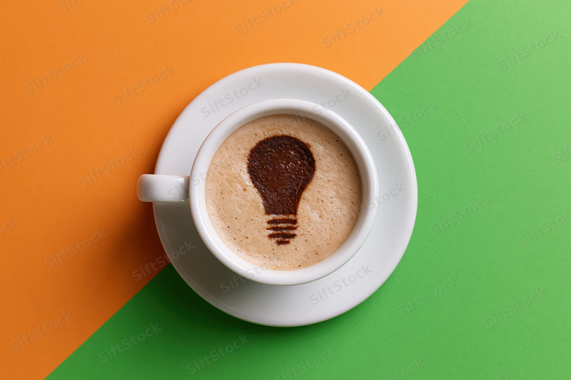 White ceramic espresso cup with lightbulb latte art on saucer over orange and green colorblock background