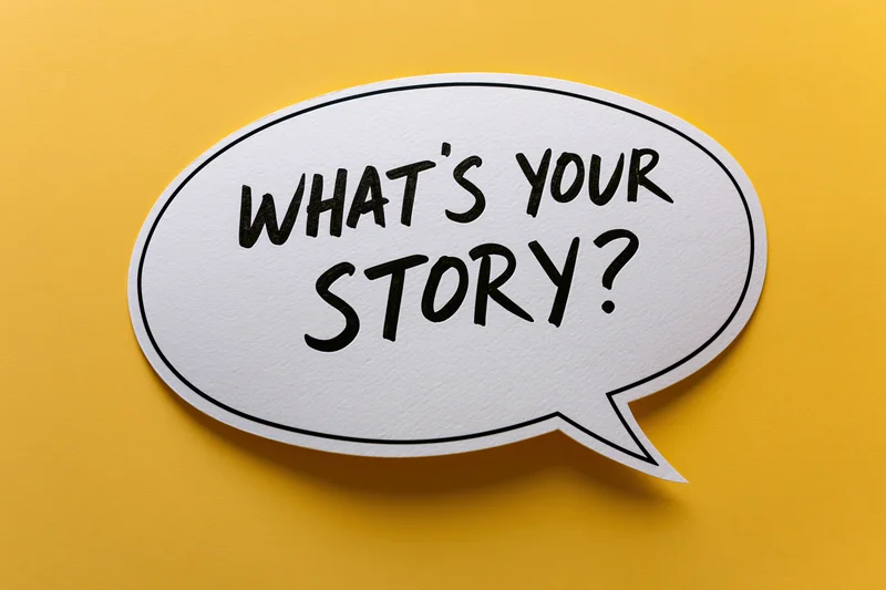 White speech bubble with bold black handwritten text reading what's your story on yellow background
