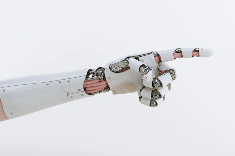 Robotic arm extended with index finger pointing forward against white background