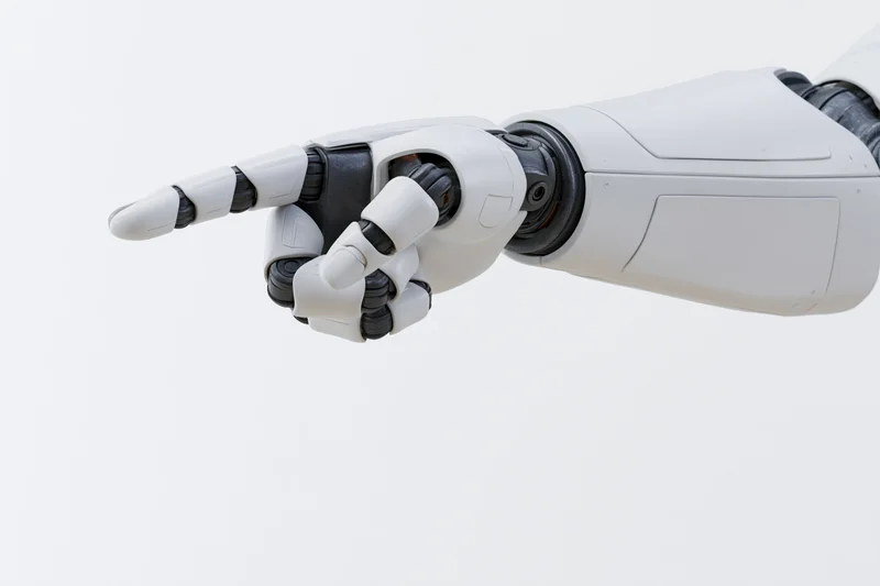 Robotic arm with hand pointing forward against white background