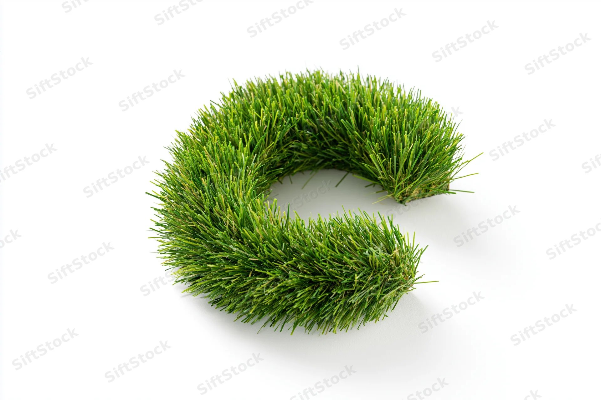 Grass shaped into letter c on white background
