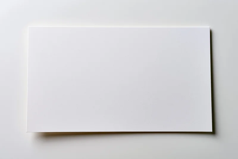 Blank white paper sheet lying flat on a light surface with soft shadow