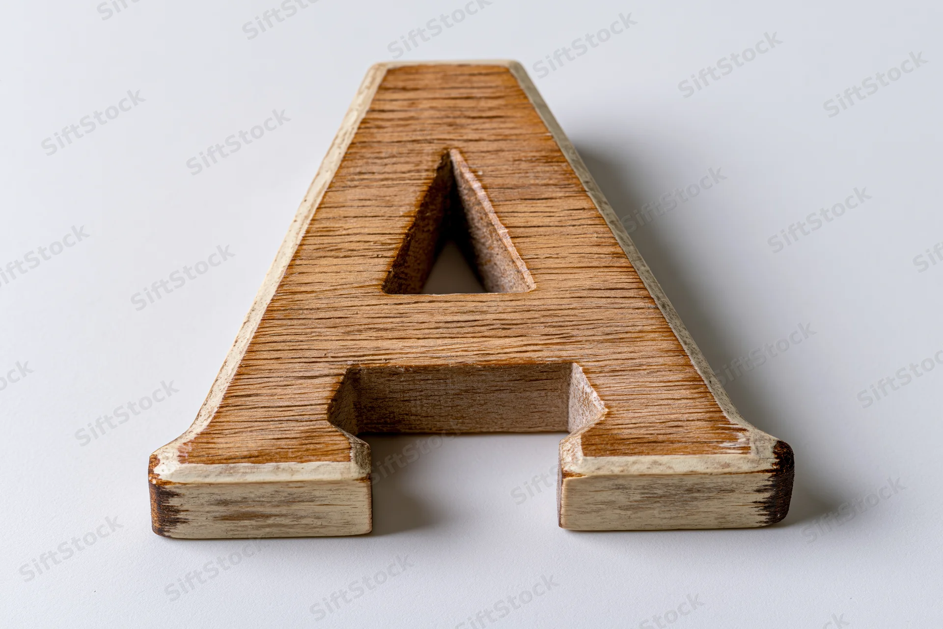 Wooden letter a toy block lying flat on white background