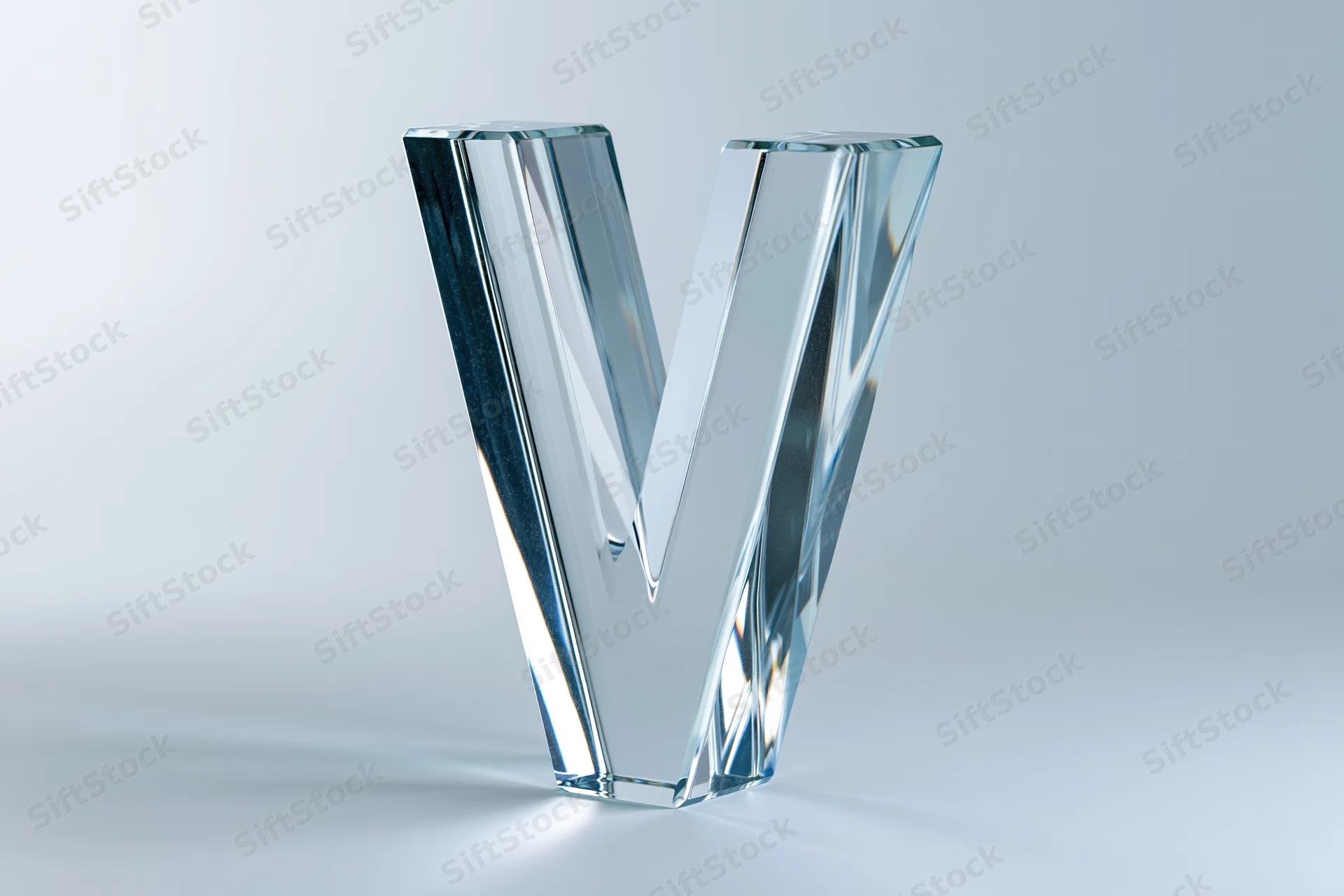 Glass letter v sculpture standing upright on white background