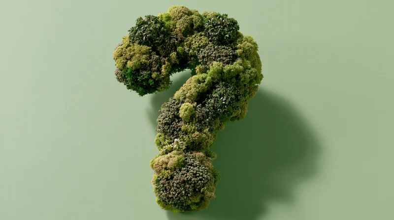 Broccoli arranged in a question mark shape on a green background