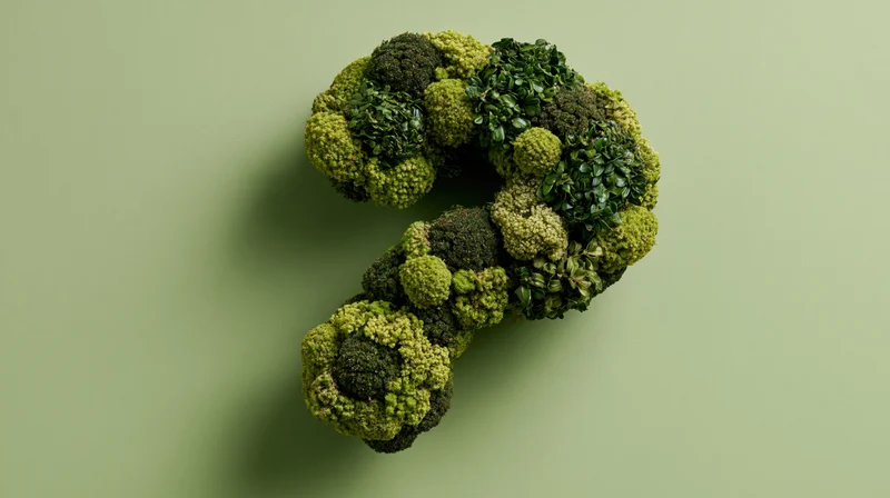 Broccoli arranged in a question mark shape on a green background
