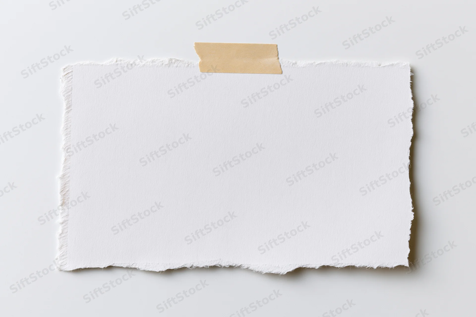 Torn white paper sheet taped to a plain surface with beige adhesive strip