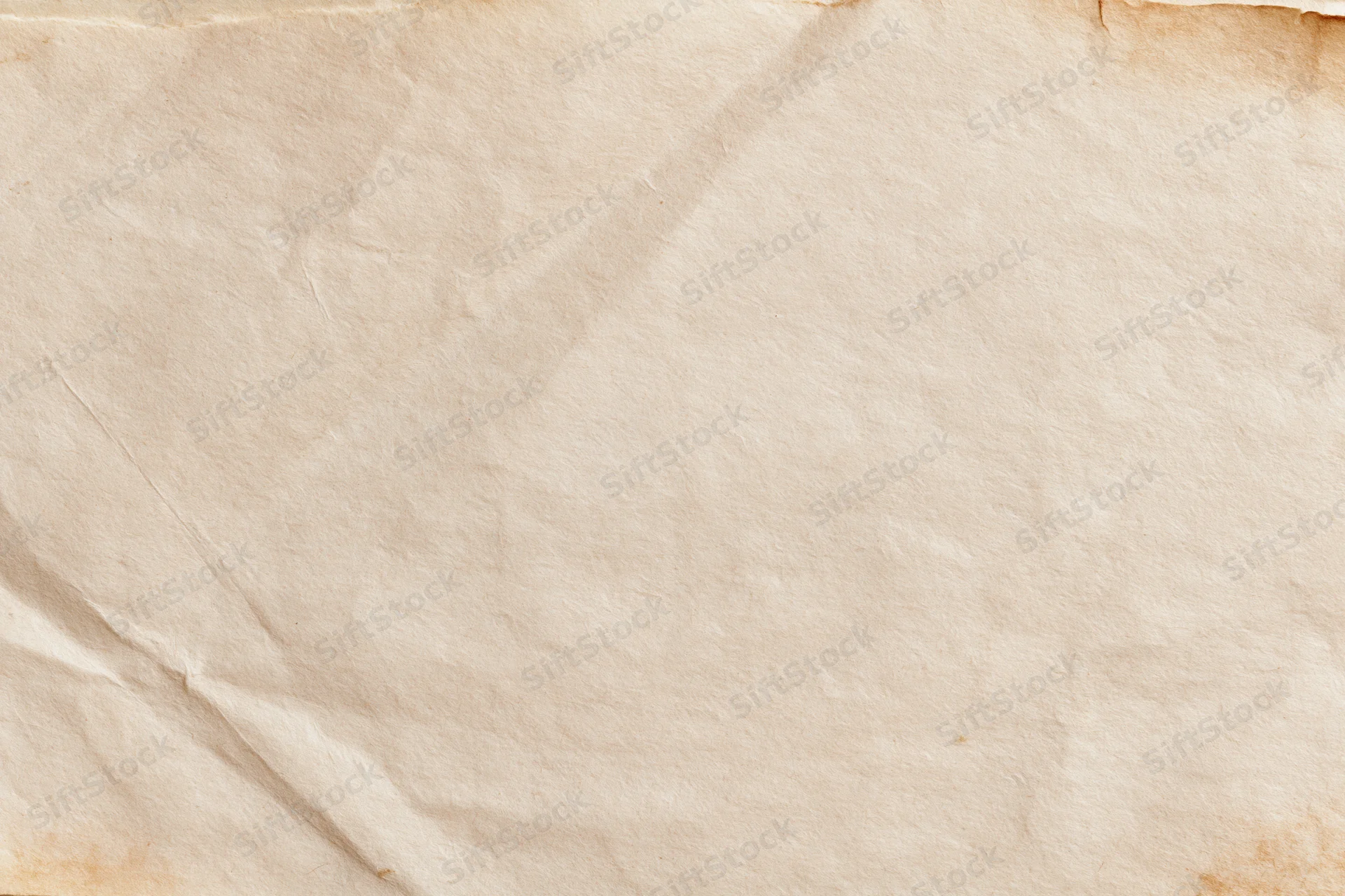 Close-up of aged crumpled paper sheet with vintage texture and warm beige tone