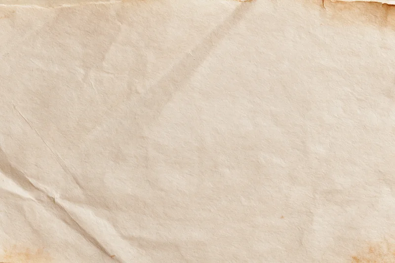 Close-up of aged crumpled paper sheet with vintage texture and warm beige tone