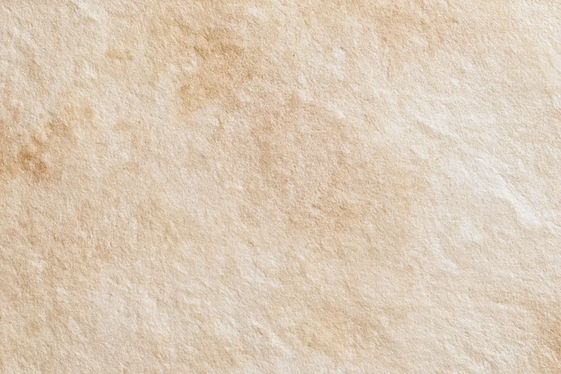 Aged plaster wall surface filling the frame with textured beige finish