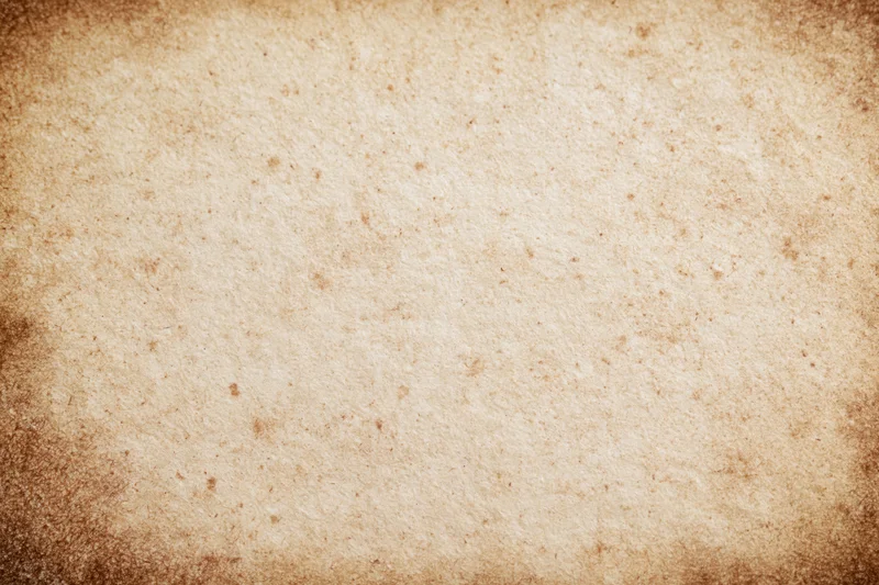 Aged parchment paper texture filling the frame with vintage brown tones and distressed surface