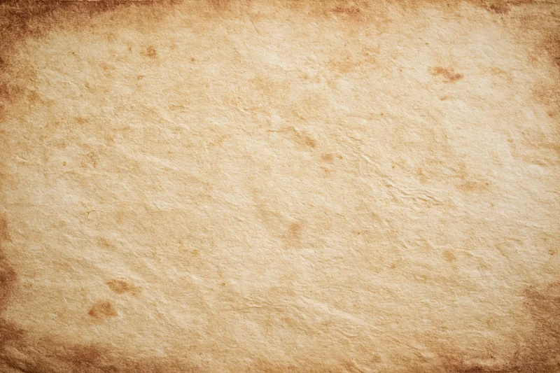 Aged parchment paper texture filling the frame with distressed edges and uneven surface