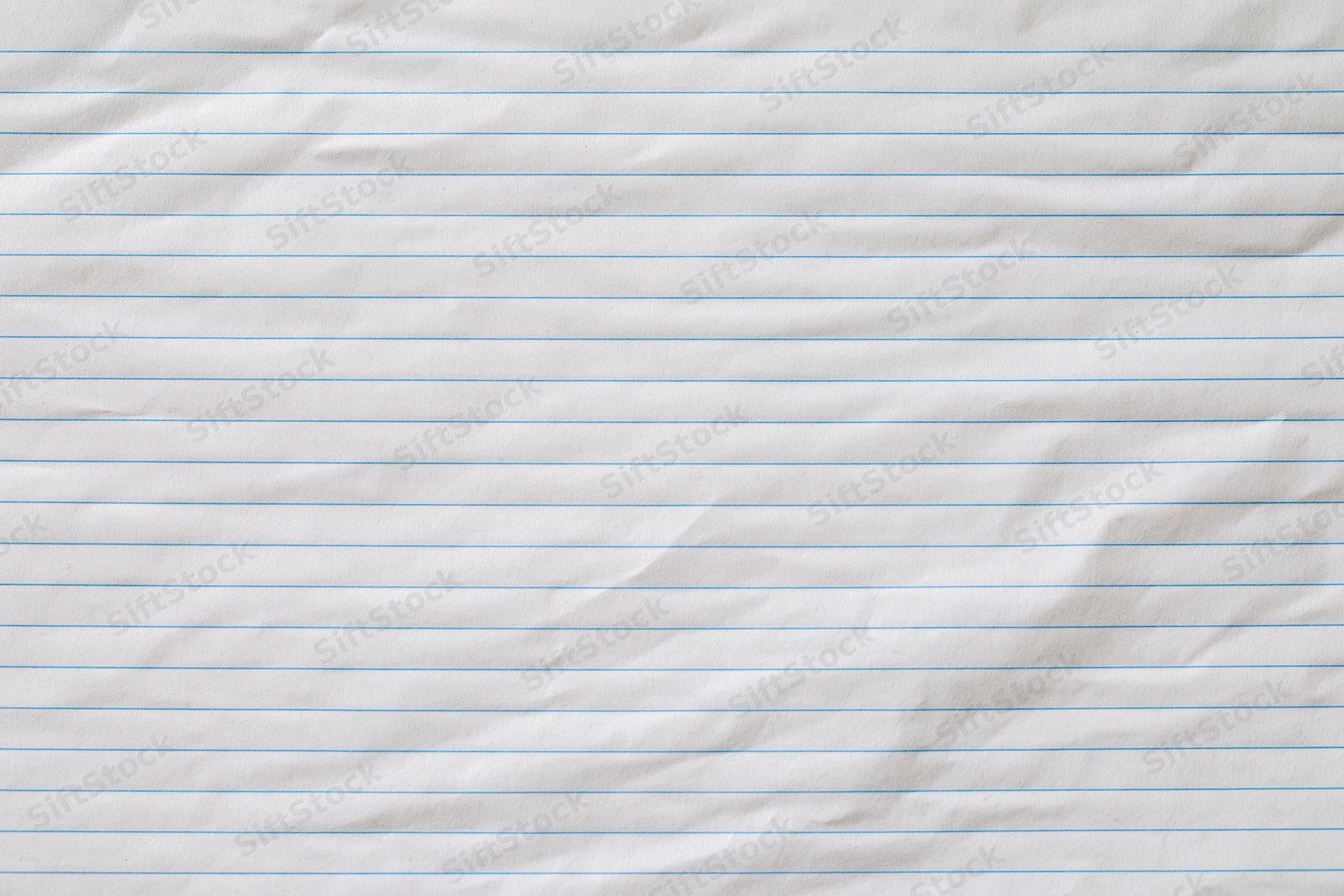 Crumpled lined notebook paper filling the frame as a textured background