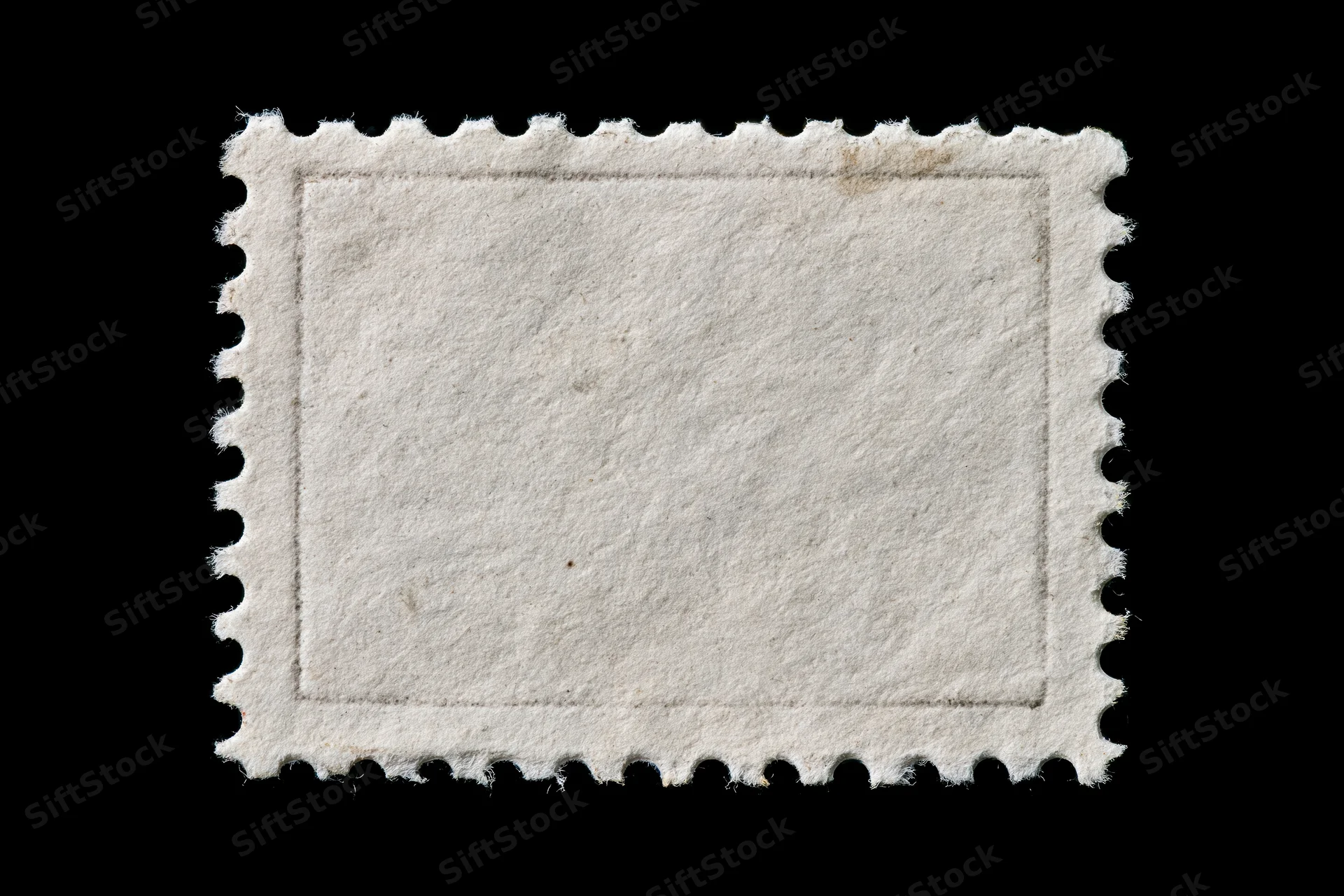 Blank postage stamp with perforated edges on black background