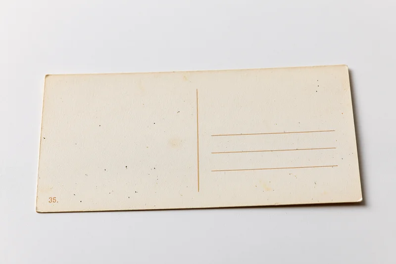 Vintage blank postcard back side lying flat on white surface