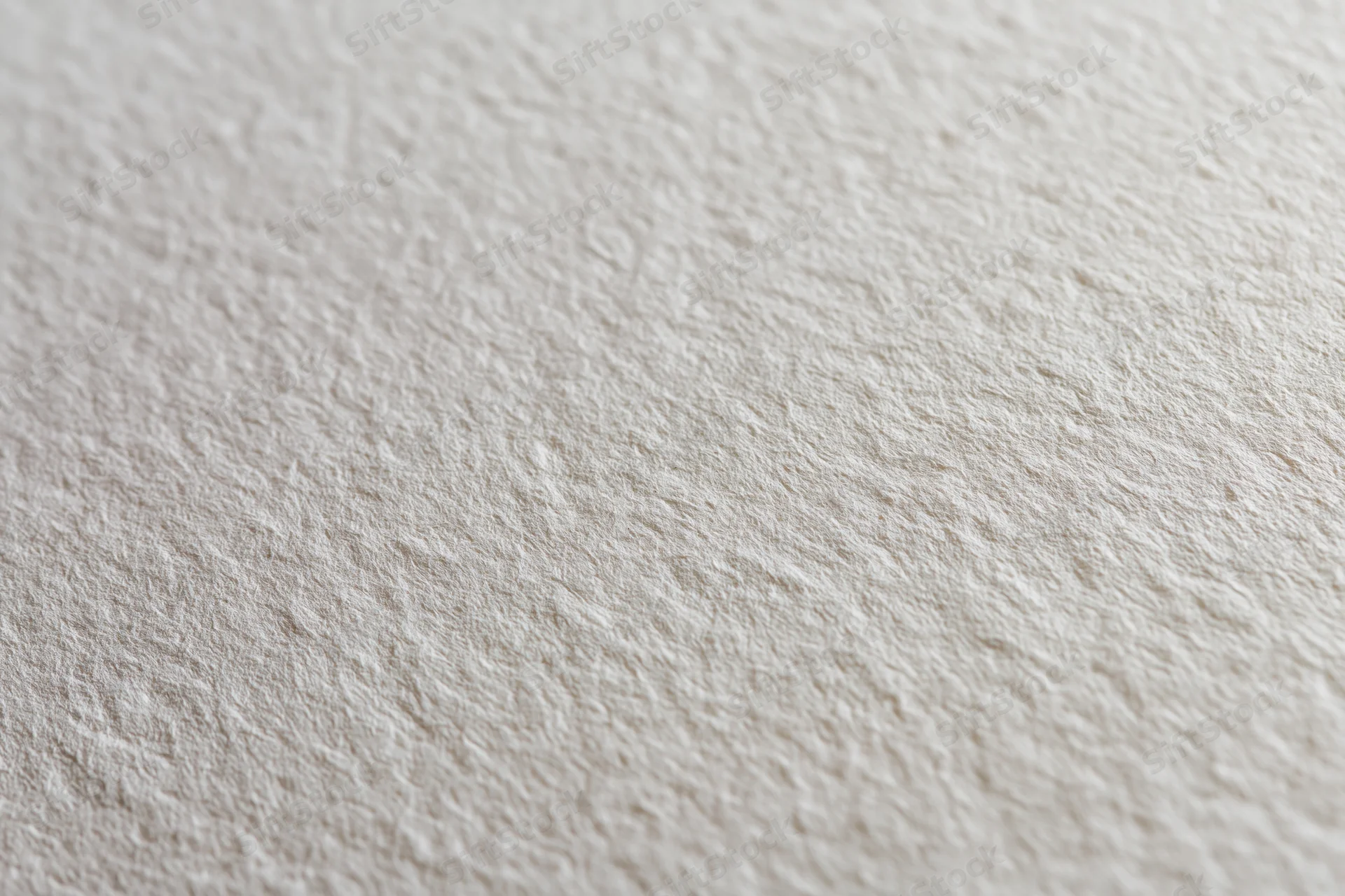 Close-up of a blank sheet of watercolor paper showing its textured surface