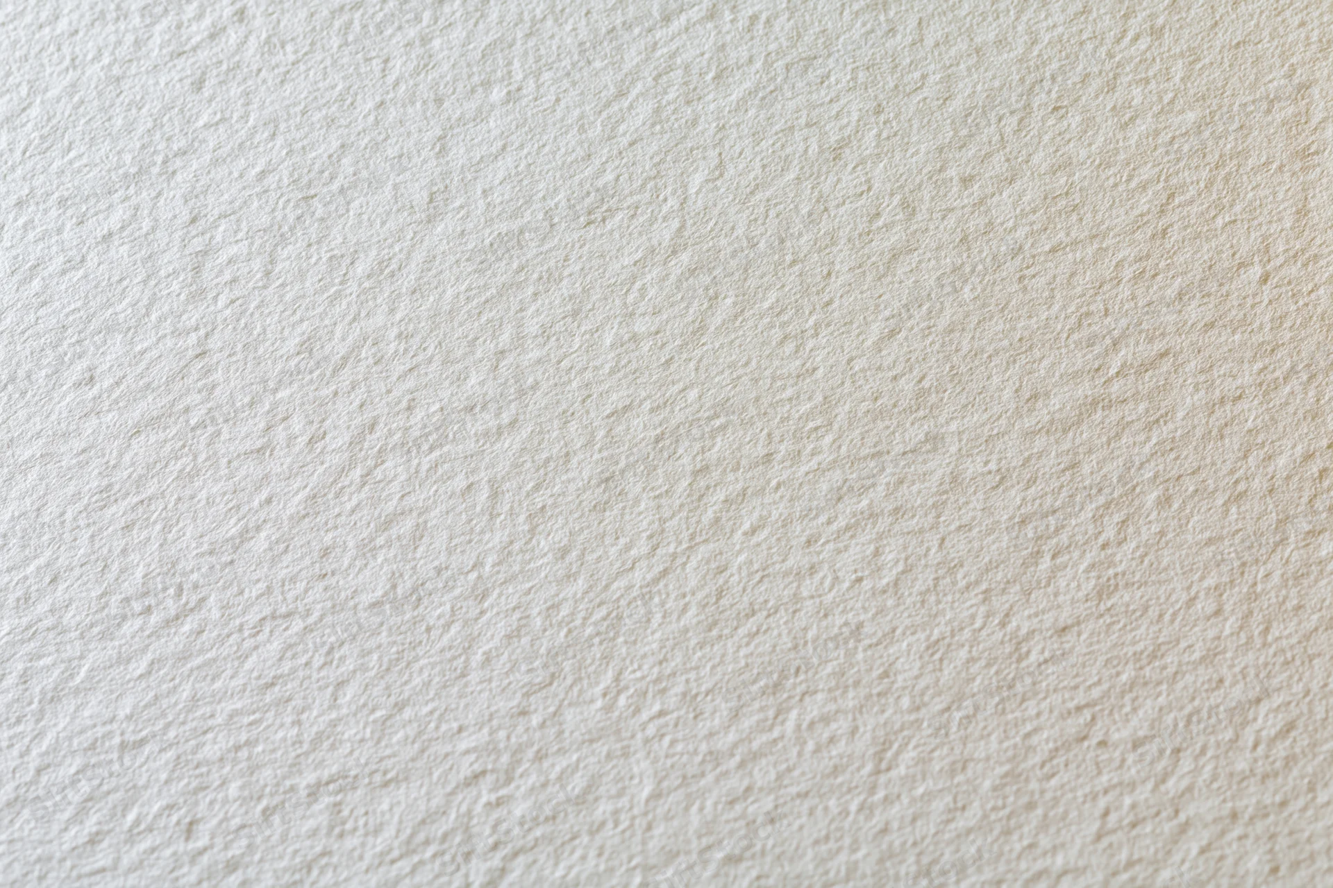 Close-up of a blank sheet of watercolor paper showing its textured surface