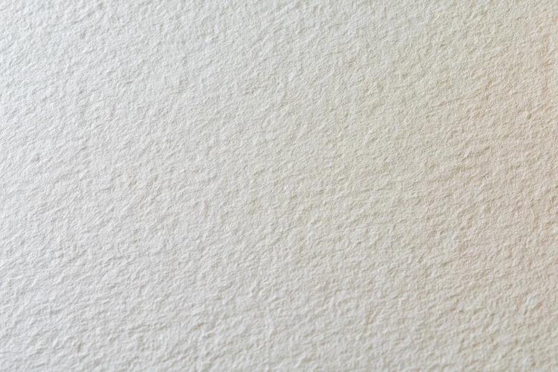 Close-up of a blank sheet of watercolor paper showing its textured surface