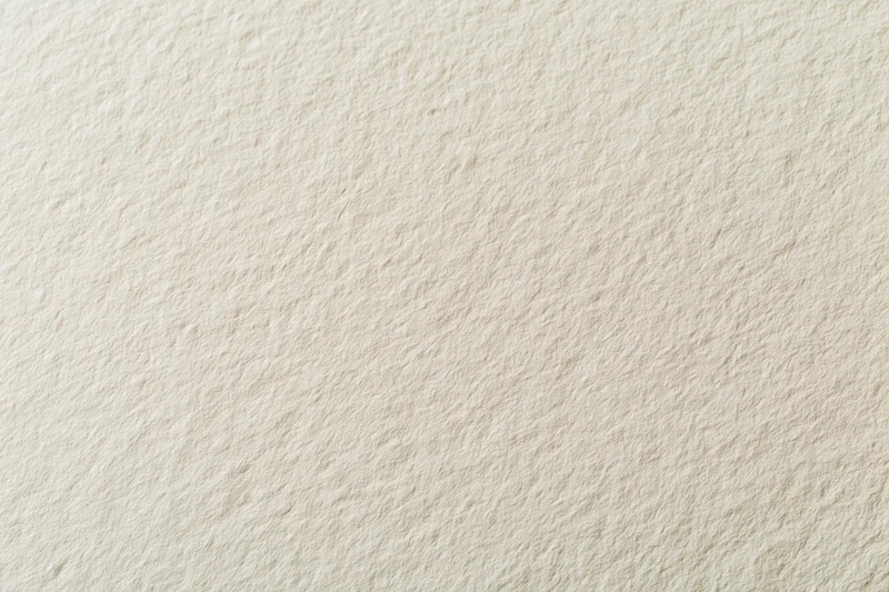 Close-up of a blank sheet of watercolor paper showing its textured surface