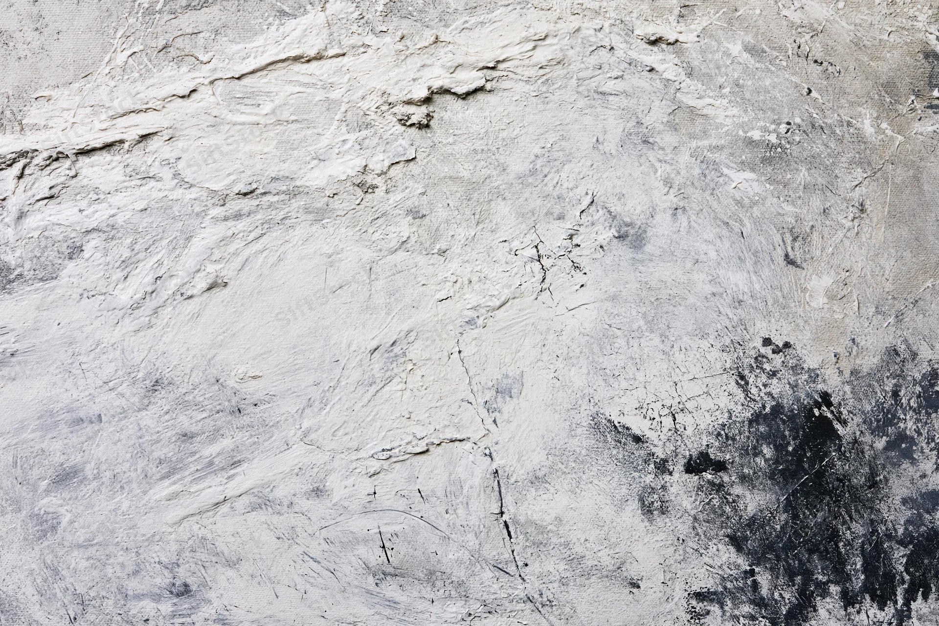 Close-up of abstract painted canvas with thick textured paint strokes in white gray and black